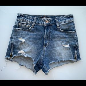 Regular blue jeans with a few mini rips and two small zippers on each side